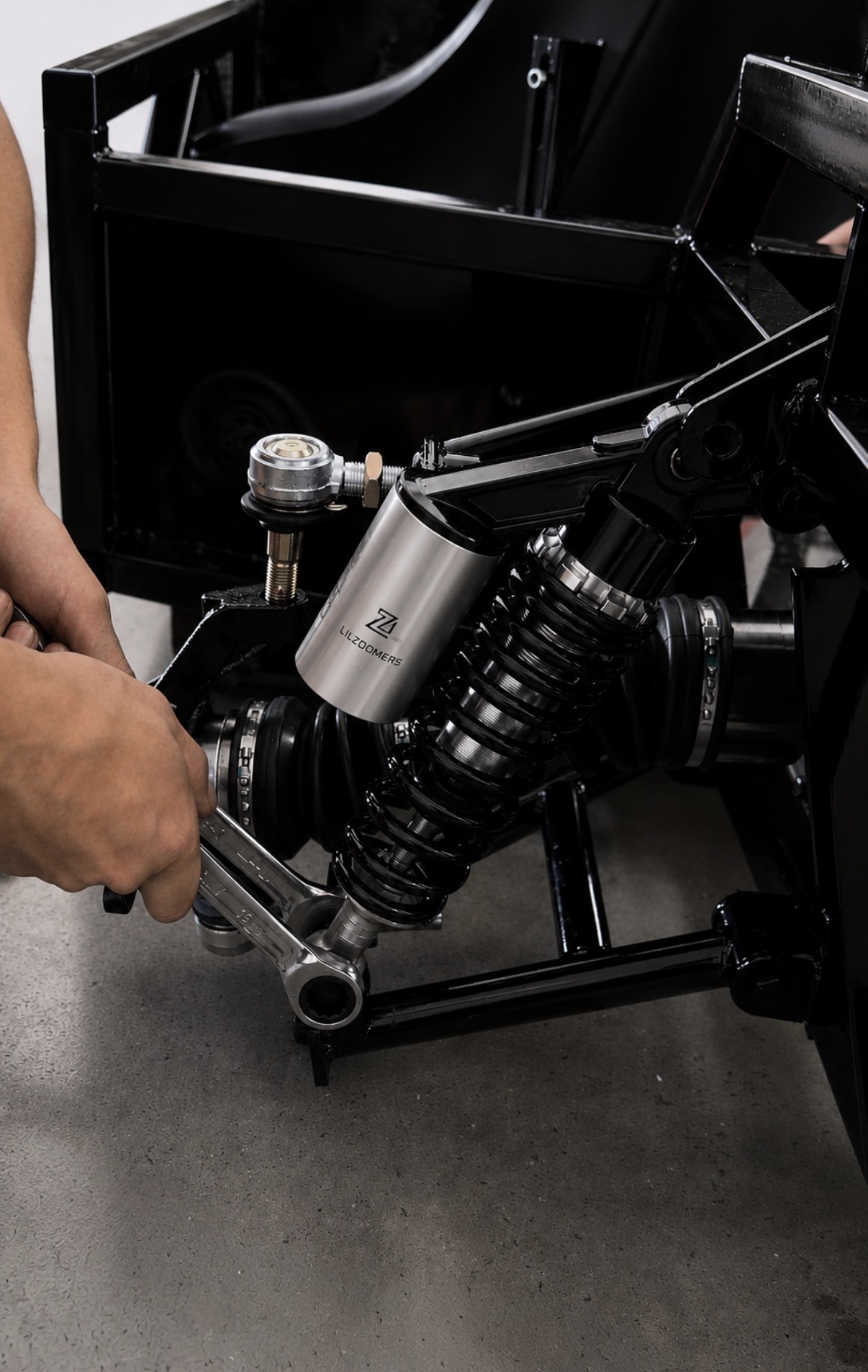 LIL ZOOMERS branded coilover being installed